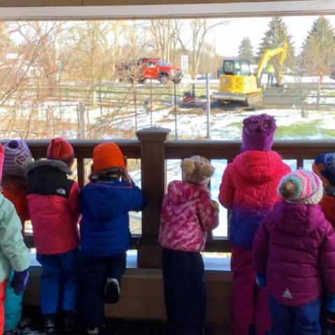 Children looking out the window at construction 